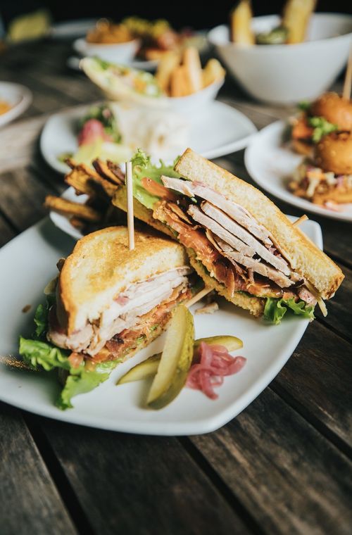 Club sandwich with pickle and chips